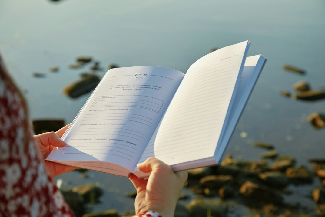person journaling in morning light