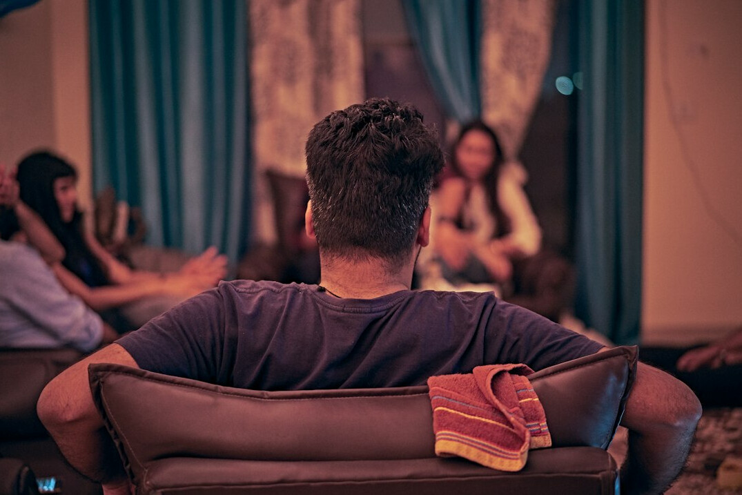 Diverse group of Brazilian people engaged in a warm conversation during a workshop