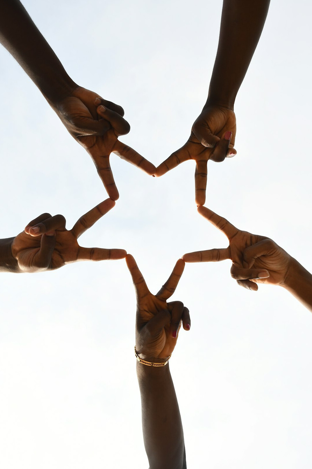 Diverse hands joined together in a circle representing unity